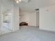 Spacious living room showcasing neutral carpet and an open layout to the kitchen at 904 Harbor Town Dr, Venice, FL 34292