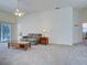 Cozy living room with neutral carpet, ample natural light, and comfortable furnishings at 904 Harbor Town Dr, Venice, FL 34292