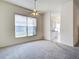 Bright living room with neutral carpet, ceiling fan, and large window at 904 Harbor Town Dr, Venice, FL 34292