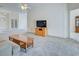 Open living room boasts neutral carpet and is filled with natural light from windows at 904 Harbor Town Dr, Venice, FL 34292