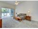 Comfortable living room with sliding doors, neutral carpet, and natural light at 904 Harbor Town Dr, Venice, FL 34292