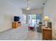 Open living room leads to screened patio with neutral carpet and natural light at 904 Harbor Town Dr, Venice, FL 34292
