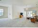 Open living room boasts neutral carpet and is filled with natural light from windows at 904 Harbor Town Dr, Venice, FL 34292