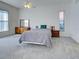 Main bedroom featuring neutral carpet, large windows, and a ceiling fan at 904 Harbor Town Dr, Venice, FL 34292