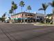 Street view with mature trees, shops, and colorful awnings at 904 Harbor Town Dr, Venice, FL 34292