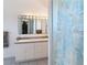 Bright bathroom featuring a double sink vanity, modern fixtures, and a nautical themed shower curtain at 919 Key Way, Nokomis, FL 34275