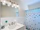 Modern bathroom featuring starfish curtain and a vanity with bright lighting at 919 Key Way, Nokomis, FL 34275