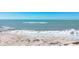 Gentle waves lap against the sandy shore in this peaceful beach scene at 919 Key Way, Nokomis, FL 34275