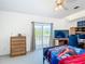 Bright bedroom features a sliding glass door with access to a balcony at 919 Key Way, Nokomis, FL 34275