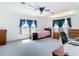 Bright bedroom with water view windows, carpet flooring, and ceiling fan, offering a peaceful retreat at 919 Key Way, Nokomis, FL 34275