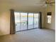 Bedroom featuring waterfront views through a large sliding glass door, ceiling fan, and carpeted floor at 919 Key Way, Nokomis, FL 34275