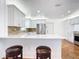 Modern kitchen showcasing white cabinets, a breakfast bar, stainless steel appliances, and charming tiled floors at 919 Key Way, Nokomis, FL 34275