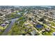 A beautiful aerial view of the neighborhood with waterfront access and lush green vegetation at 951 Sea Fox Rd, Venice, FL 34293