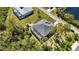 Aerial shot of a home with a screened pool and manicured yard in a serene neighborhood at 951 Sea Fox Rd, Venice, FL 34293