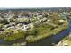Community aerial view showcasing waterfront homes, lush landscaping and waterway access at 951 Sea Fox Rd, Venice, FL 34293