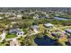 Community aerial view showcasing waterfront homes, lush landscaping and waterway access at 951 Sea Fox Rd, Venice, FL 34293