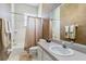 Bathroom with tile shower, neutral colored walls, and single sink at 951 Sea Fox Rd, Venice, FL 34293