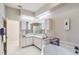 Bright bathroom with dual sinks, soaking tub, and tile flooring at 951 Sea Fox Rd, Venice, FL 34293