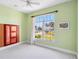 Bedroom with a large arched window and decorative molding at 951 Sea Fox Rd, Venice, FL 34293
