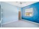Light blue bedroom with mural on wall and view to front yard at 951 Sea Fox Rd, Venice, FL 34293