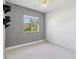 Bedroom with large window and view of lush greenery at 951 Sea Fox Rd, Venice, FL 34293