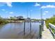 Private dock with a boat lift, offering convenient access to the waterfront at 951 Sea Fox Rd, Venice, FL 34293