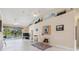 Bright living room with tiled floors, fireplace, and sliding glass doors that open to the screened lanai and pool at 951 Sea Fox Rd, Venice, FL 34293