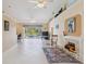 Bright living room featuring tile floors, fireplace, and a view of the pool at 951 Sea Fox Rd, Venice, FL 34293