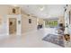 Spacious living area with tile floors, high ceilings, and views of the screened lanai and pool at 951 Sea Fox Rd, Venice, FL 34293