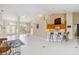 Bright, open floor plan with neutral tile floors, high ceilings, and breakfast bar with chairs at 951 Sea Fox Rd, Venice, FL 34293