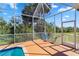 Relaxing screened-in pool area with chairs and peaceful view at 951 Sea Fox Rd, Venice, FL 34293