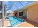 The enclosed pool features a tiled deck and glass enclosure with patio access at 951 Sea Fox Rd, Venice, FL 34293