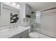 Bathroom includes a marble top vanity, updated lighting, and a shower-tub combination with sliding doors at 990 Bird Bay Way # 258, Venice, FL 34285
