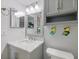 Charming bathroom features a marble vanity top, stainless steel faucet, and decorative wall art at 990 Bird Bay Way # 258, Venice, FL 34285