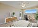 Bright bedroom featuring a king bed, dresser, and seating area at 990 Bird Bay Way # 258, Venice, FL 34285