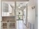 Bright kitchen featuring white cabinets, granite countertops and a breakfast bar with seating at 990 Bird Bay Way # 258, Venice, FL 34285