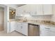 Beautiful kitchen with granite countertops, stainless steel dishwasher, and white cabinetry at 990 Bird Bay Way # 258, Venice, FL 34285