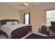 Comfortable bedroom with ceiling fan, stylish rug, and decorative bedding at 1000 Gardens Edge Dr # 1023, Venice, FL 34285