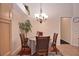 Cozy dining room with a round table, seating for four, and elegant chandelier lighting at 1000 Gardens Edge Dr # 1023, Venice, FL 34285