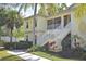 Inviting exterior showcasing the two-story home with well-manicured landscaping and white stair rails at 1000 Gardens Edge Dr # 1023, Venice, FL 34285