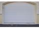 Exterior of the garage, displaying the modern, paneled garage door at 1000 Gardens Edge Dr # 1023, Venice, FL 34285