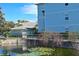 Community pond with lily pads, stone edging, and landscaping offering a peaceful view at 1000 Gardens Edge Dr # 1023, Venice, FL 34285