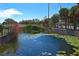 Beautiful community pond with lily pads, tropical landscaping, and a gazebo at 1000 Gardens Edge Dr # 1023, Venice, FL 34285