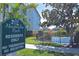 Welcoming sign for Magnolia Park community with a view of the pond and residence buildings at 1000 Gardens Edge Dr # 1023, Venice, FL 34285