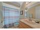 Bathroom showcasing a patterned shower curtain, a classic vanity, and neutral finishes at 1003 N Gondola Dr, Venice, FL 34293
