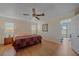 Bright bedroom with a large window, wood floors, ceiling fan and an attached sunroom at 1003 N Gondola Dr, Venice, FL 34293