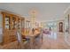 Open-concept dining area featuring tile floors, a chandelier, and seamless access to the living room, ideal for hosting guests at 1003 N Gondola Dr, Venice, FL 34293