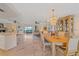 Elegant dining area with a chandelier, stylish furniture, and a seamless connection to the living area, perfect for entertaining at 1003 N Gondola Dr, Venice, FL 34293