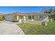 Beautiful home with a charming facade, lush green lawn, and a well-maintained exterior with lovely curb appeal at 1003 N Gondola Dr, Venice, FL 34293