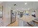 Well-lit kitchen featuring stainless steel appliances, ample counter space, and bar seating at 1003 N Gondola Dr, Venice, FL 34293